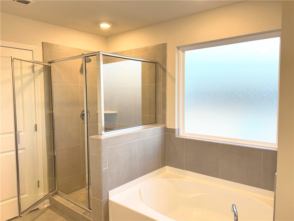 6901 Durham Lane Fairburn, GA 30213 - Photo 16 of 29 a bathroom with a shower and a glass door