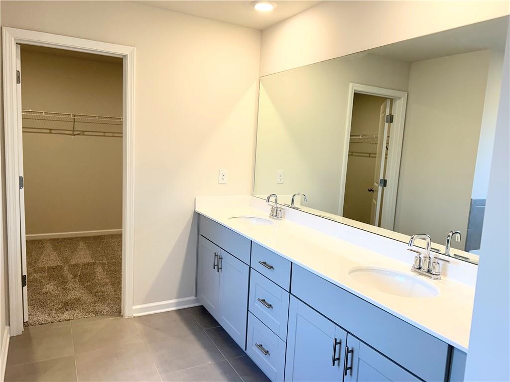 6901 Durham Lane Fairburn, GA 30213 - Photo 17 of 29 a bathroom with a double vanity sink and mirror