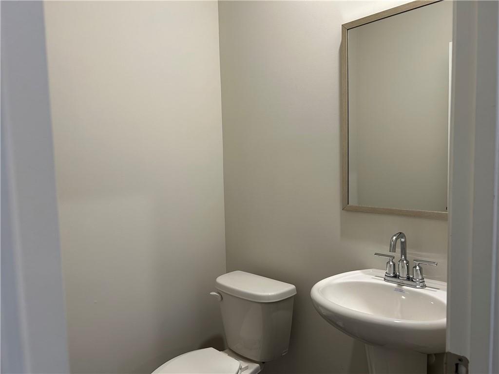 6901 Durham Lane Fairburn, GA 30213 - Photo 25 of 29 a bathroom with a toilet sink and mirror