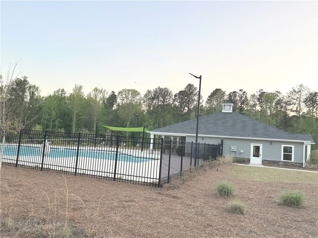 6901 Durham Lane Fairburn, GA 30213 - Photo 27 of 29 a view of a backyard with a fence and a tree