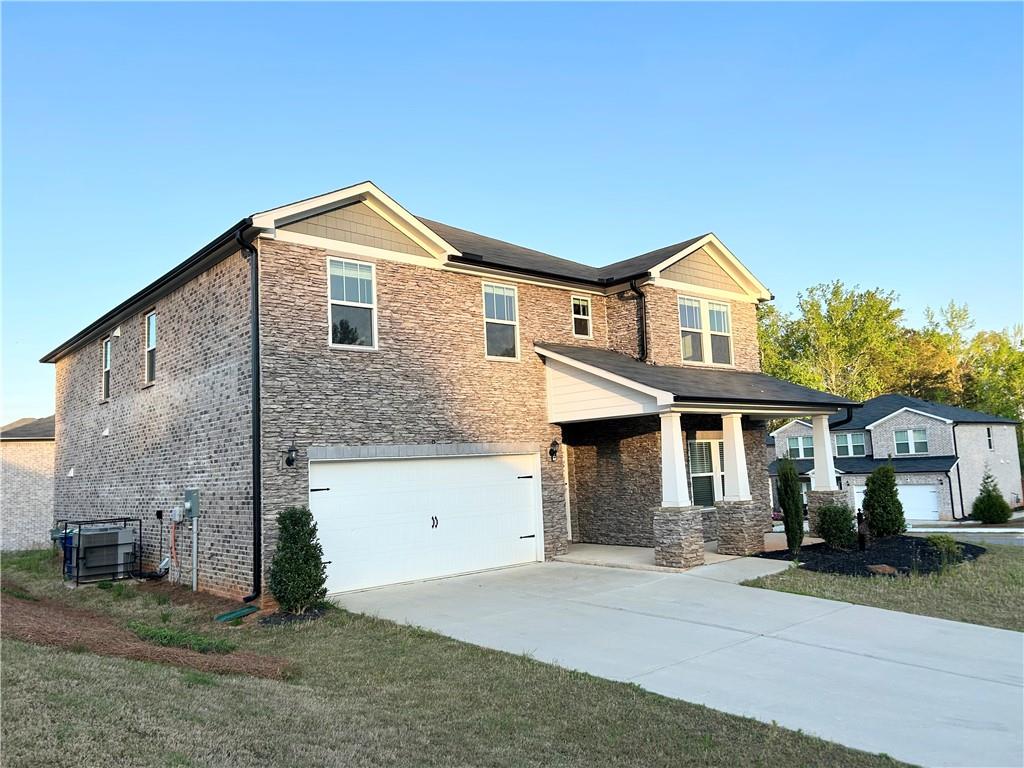 6901 Durham Lane Fairburn, GA 30213 - Photo 4 of 29 a front view of a house with a yard and garage