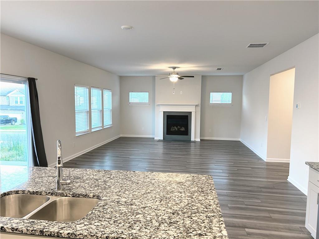 6901 Durham Lane Fairburn, GA 30213 - Photo 5 of 29 a living room with wooden floor and a fireplace