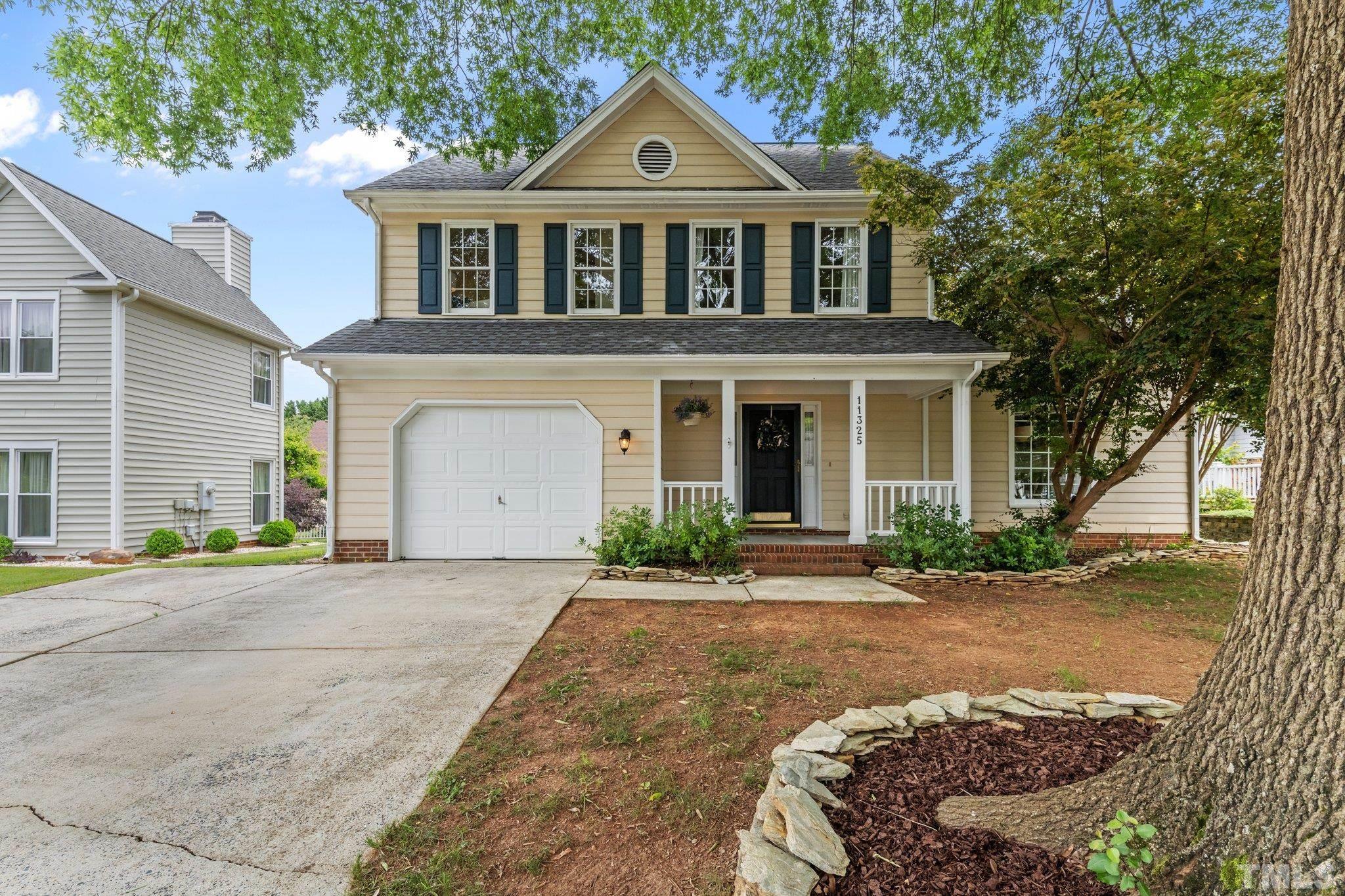 11325 North Radner Way Raleigh, NC 27613 - Photo 1 of 29 a front view of a house with a yard and garage