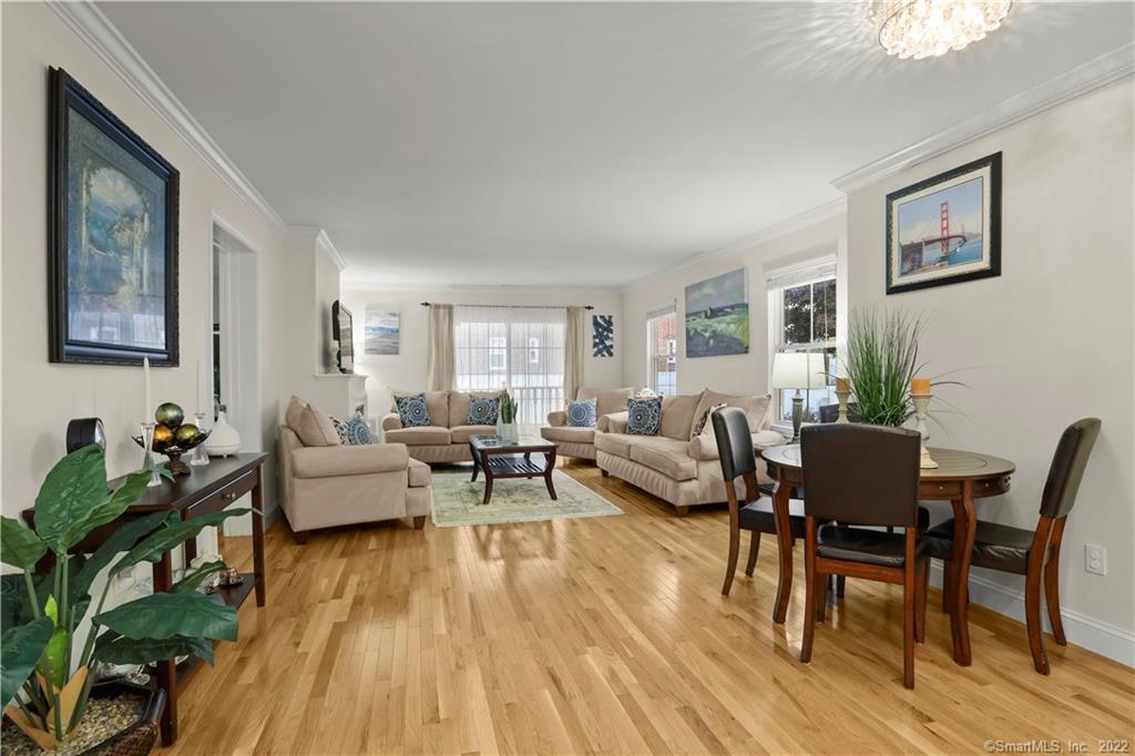 49 Glenbrook Road, Unit 104 Stamford, CT 06902 - Photo 1 of 1 a living room with furniture and wooden floor