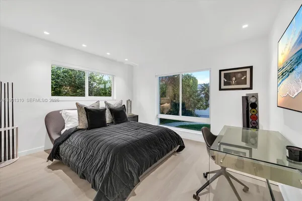 a living room with a bed furniture and a large window