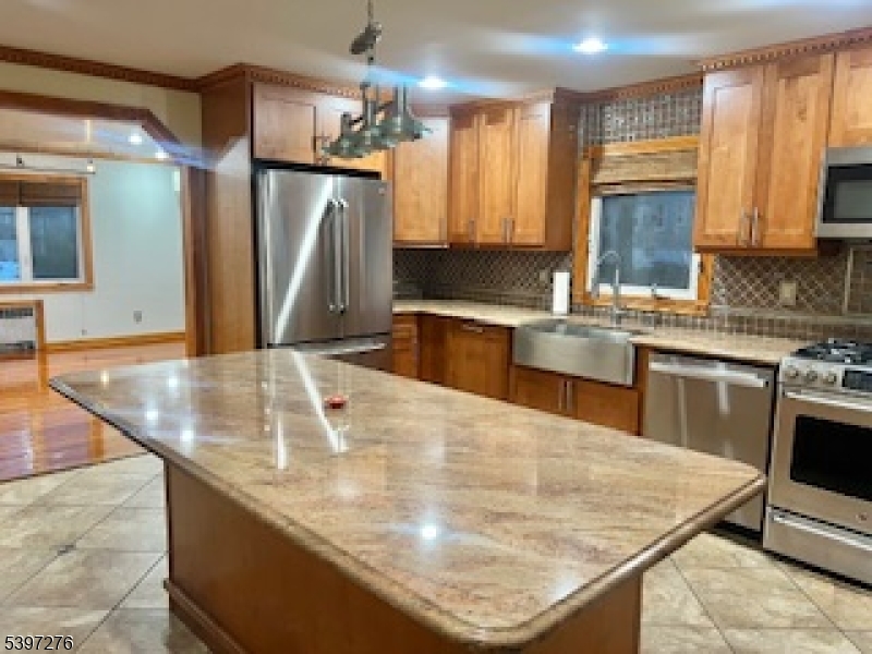 3 Freeman Place Nutley, NJ 07110 - Photo 3 of 12 a kitchen with stainless steel appliances granite countertop a sink a stove and a refrigerator