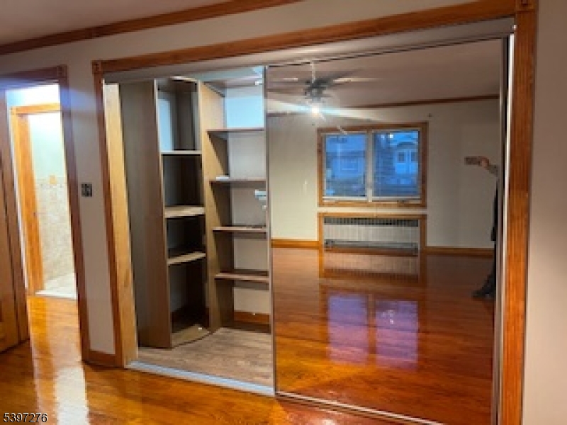 3 Freeman Place Nutley, NJ 07110 - Photo 6 of 12 a view of a hallway with wooden floor and dining room