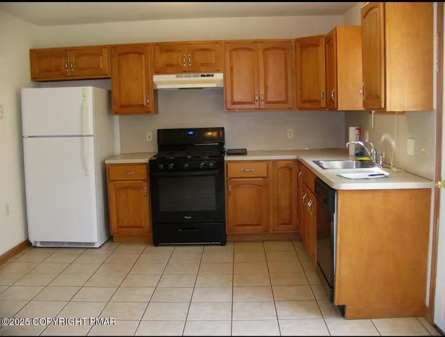 a kitchen with a refrigerator and a sink