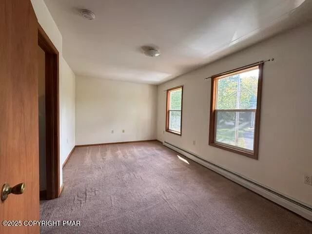 an empty room with windows and closet