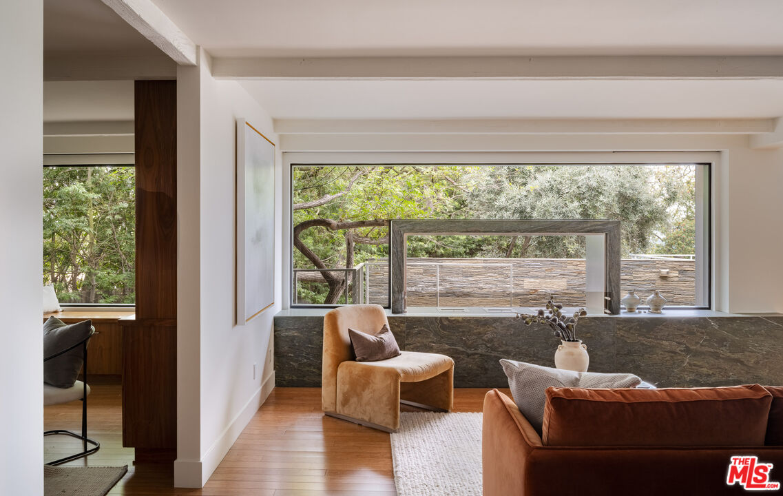 1575 Carla Ridge Beverly Hills, CA 90210 - Photo 11 of 39 a living room with furniture and a large window