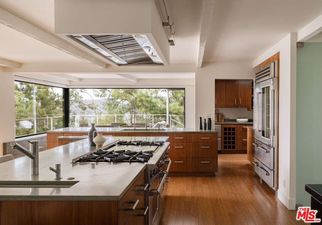 1575 Carla Ridge Beverly Hills, CA 90210 - Photo 14 of 39 a living room with furniture stove and a large window
