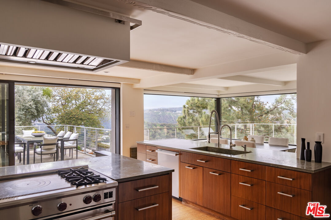 1575 Carla Ridge Beverly Hills, CA 90210 - Photo 15 of 39 a kitchen with stainless steel appliances cabinets and a stove