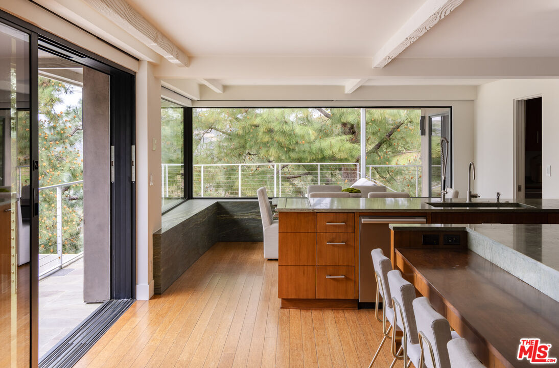 1575 Carla Ridge Beverly Hills, CA 90210 - Photo 16 of 39 a room with wooden floor and furniture