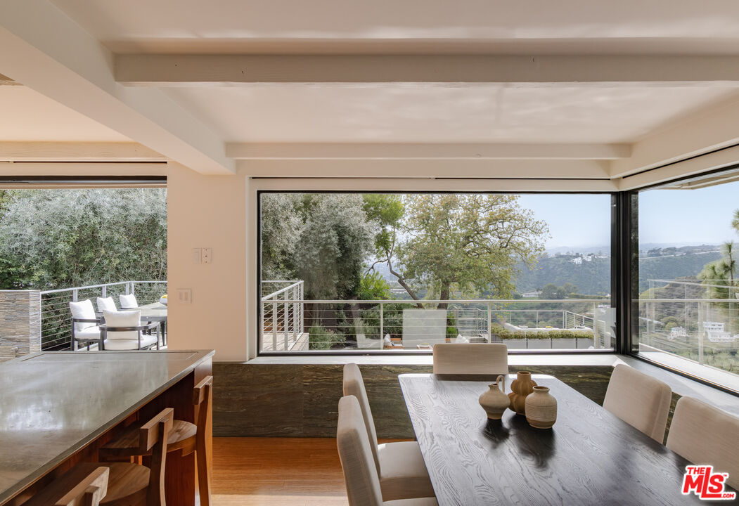 1575 Carla Ridge Beverly Hills, CA 90210 - Photo 17 of 39 a view of a living room and floor to ceiling window with an outdoor kitchen