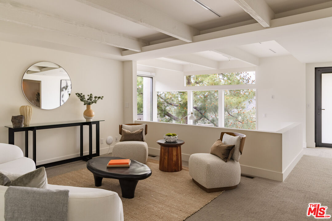 1575 Carla Ridge Beverly Hills, CA 90210 - Photo 19 of 39 a living room with furniture and a large window