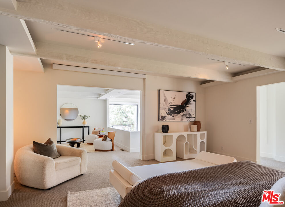 1575 Carla Ridge Beverly Hills, CA 90210 - Photo 21 of 39 a bedroom with furniture and a window
