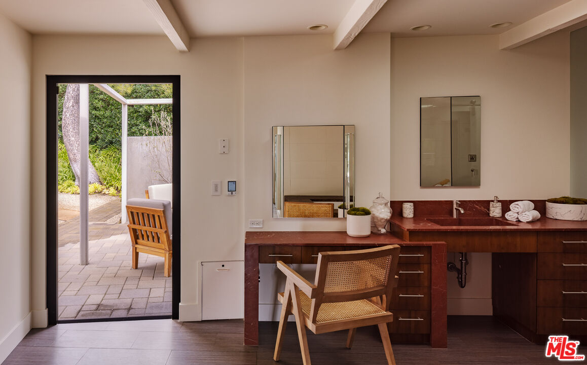 1575 Carla Ridge Beverly Hills, CA 90210 - Photo 22 of 39 a bathroom with a sink and a mirror