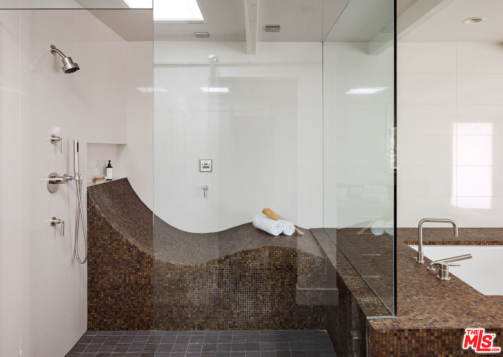 1575 Carla Ridge Beverly Hills, CA 90210 - Photo 23 of 39 a bathroom with a granite countertop sink and a mirror