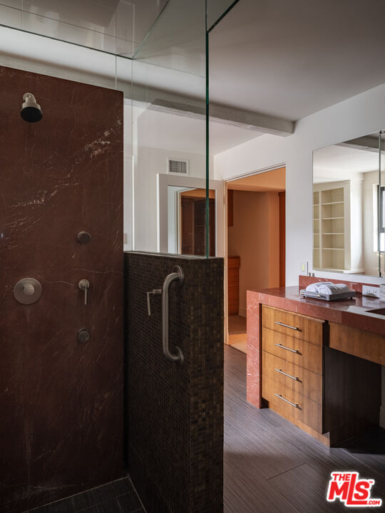 1575 Carla Ridge Beverly Hills, CA 90210 - Photo 24 of 39 a kitchen with stainless steel appliances granite countertop a refrigerator a stove and a sink with wooden floor