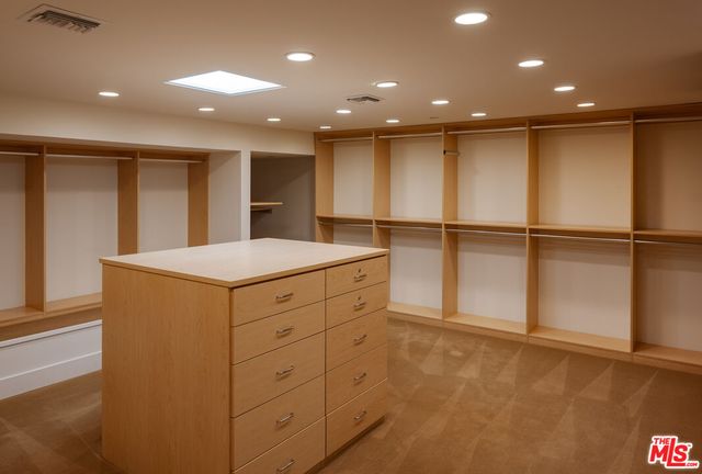 a bedroom with furniture and a large window