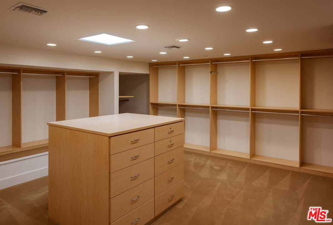 1575 Carla Ridge Beverly Hills, CA 90210 - Photo 25 of 39 a bathroom with a sink and a mirror
