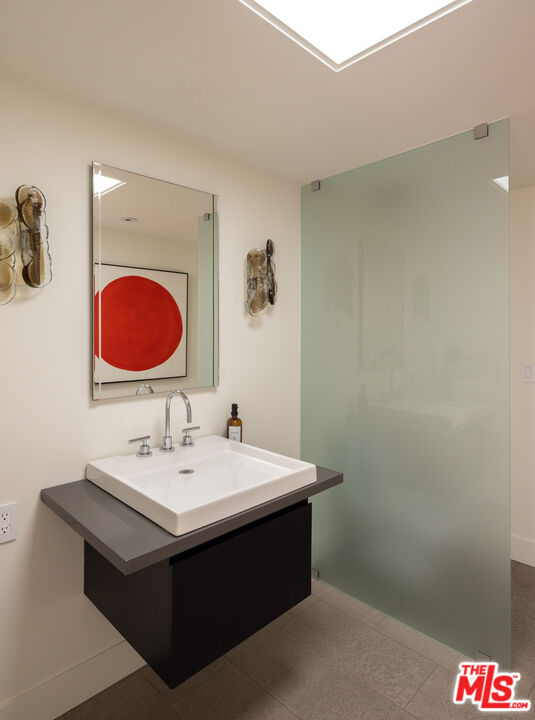 1575 Carla Ridge Beverly Hills, CA 90210 - Photo 27 of 39 a bathroom with a sink and a mirror