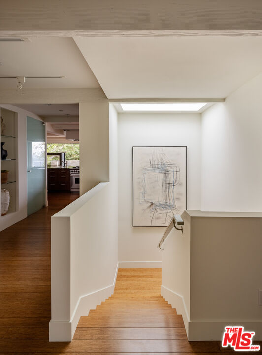 1575 Carla Ridge Beverly Hills, CA 90210 - Photo 28 of 39 a view of a hallway with wooden floor and staircase