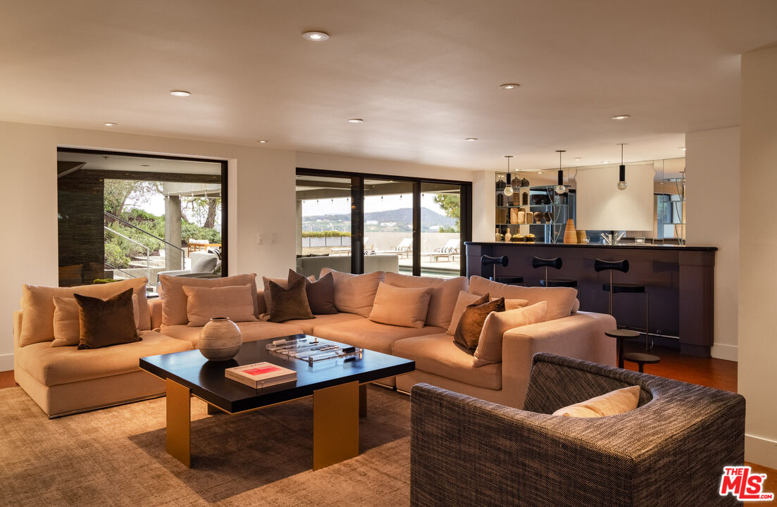1575 Carla Ridge Beverly Hills, CA 90210 - Photo 30 of 39 a living room with furniture and a large window