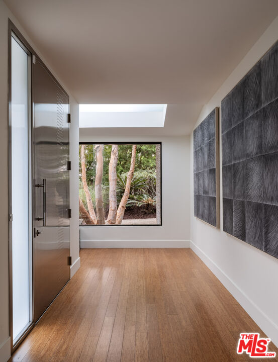 1575 Carla Ridge Beverly Hills, CA 90210 - Photo 3 of 39 wooden floor in an empty room with a window