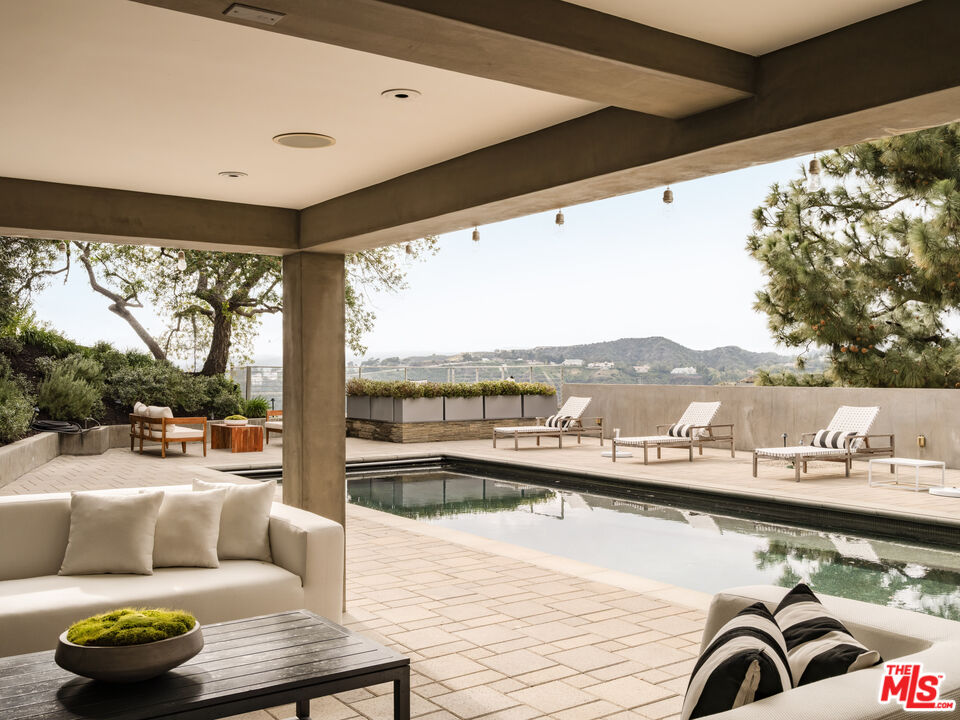 1575 Carla Ridge Beverly Hills, CA 90210 - Photo 35 of 39 a living room with furniture and a large window