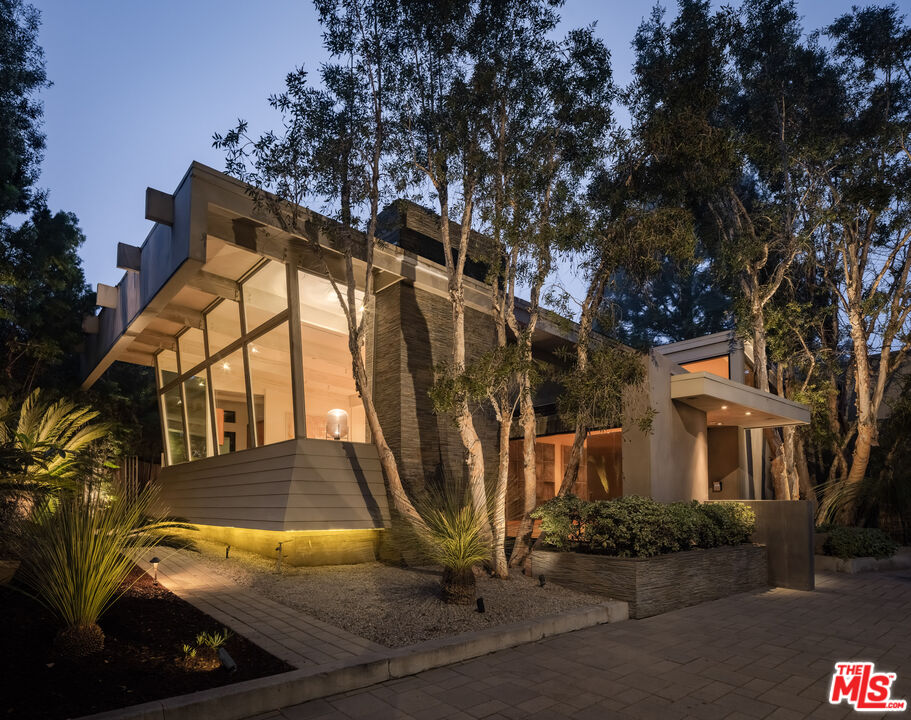 1575 Carla Ridge Beverly Hills, CA 90210 - Photo 38 of 39 a view of a house with a large tree and wooden fence