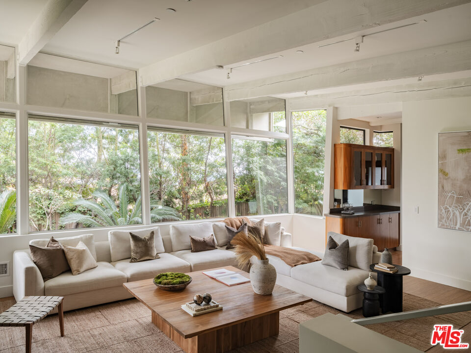 1575 Carla Ridge Beverly Hills, CA 90210 - Photo 7 of 39 a living room with furniture and a large window
