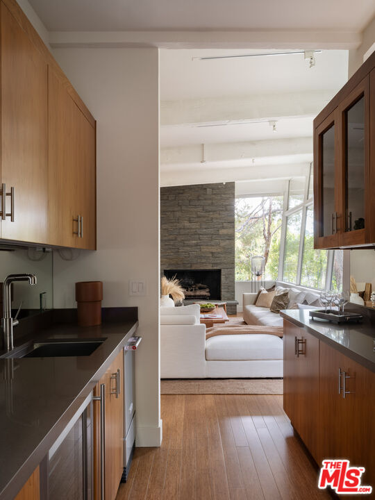 1575 Carla Ridge Beverly Hills, CA 90210 - Photo 8 of 39 a kitchen with a sink stove top oven and cabinets