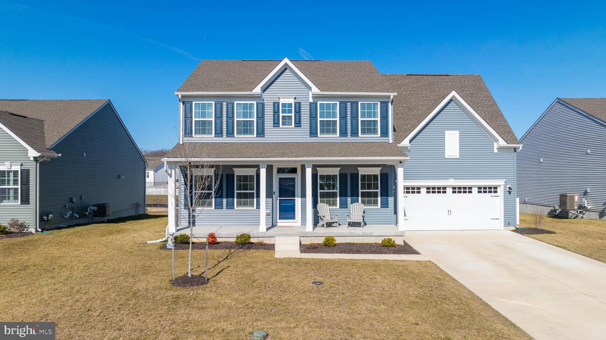 a front view of a house with a chairs and table in a patio