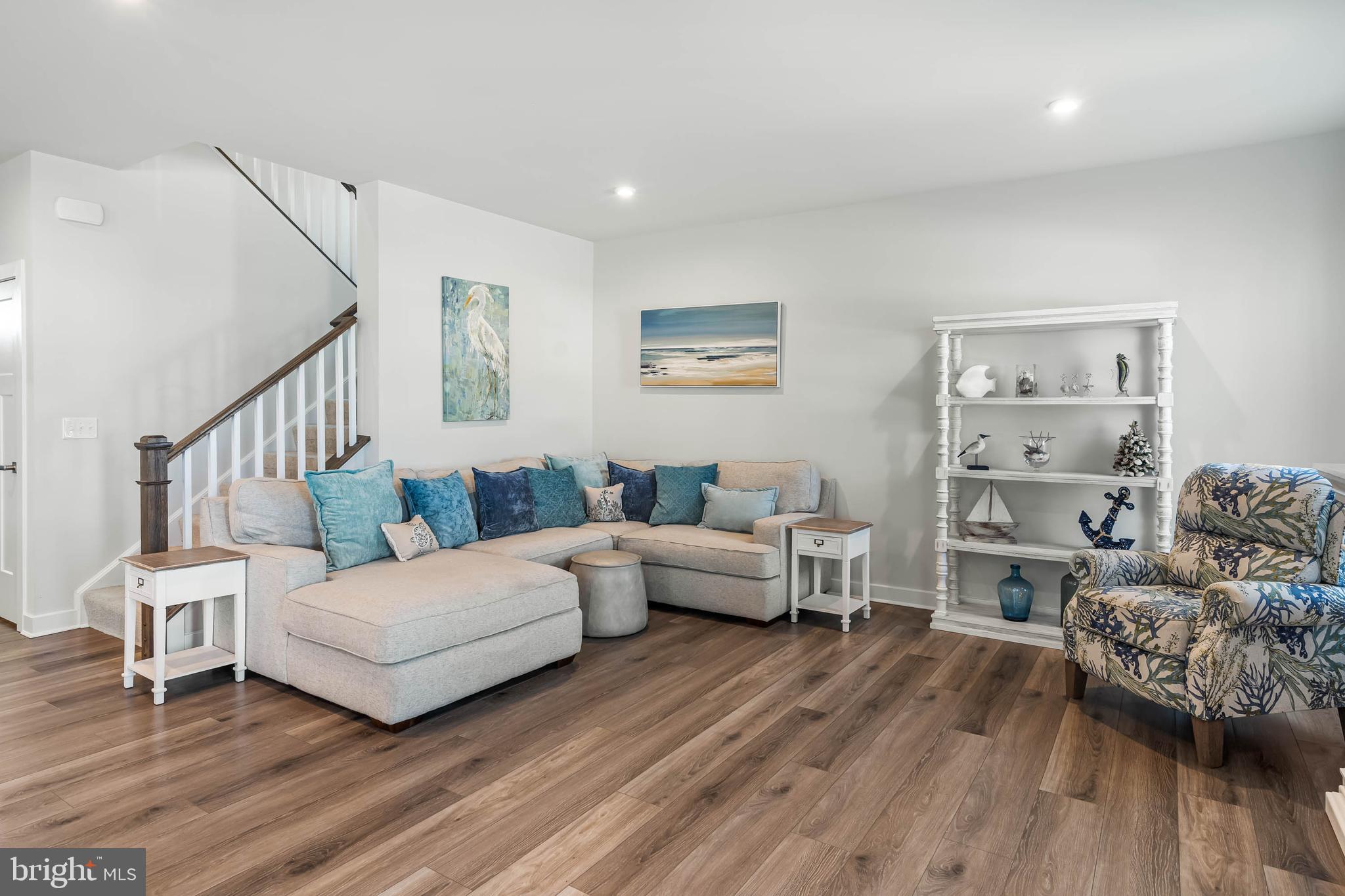 19079 Trimaran Drive Lewes, DE 19958 - Photo 17 of 61 a living room with furniture and a wooden floor