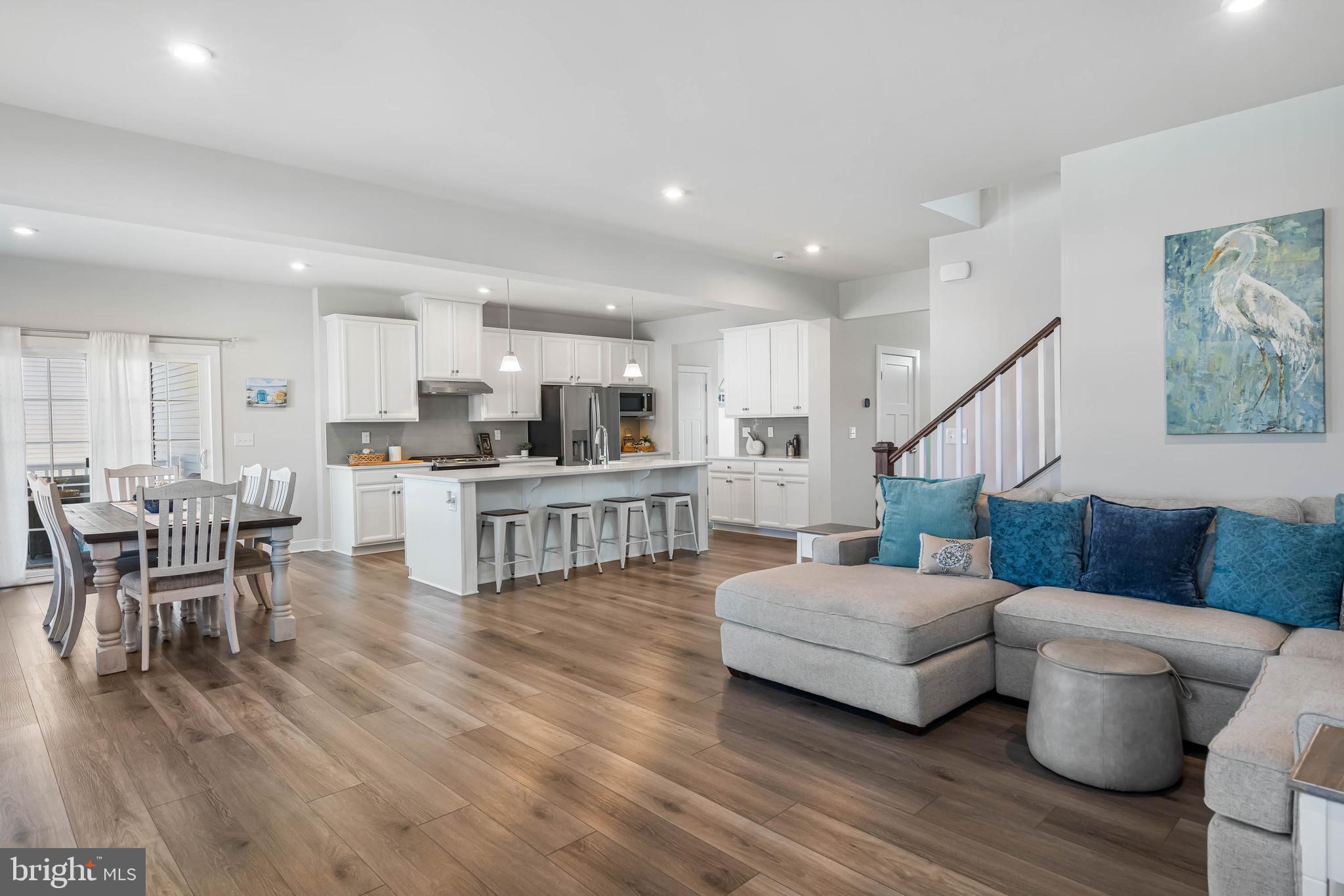 19079 Trimaran Drive Lewes, DE 19958 - Photo 18 of 61 a living room with furniture and kitchen view with wooden floor