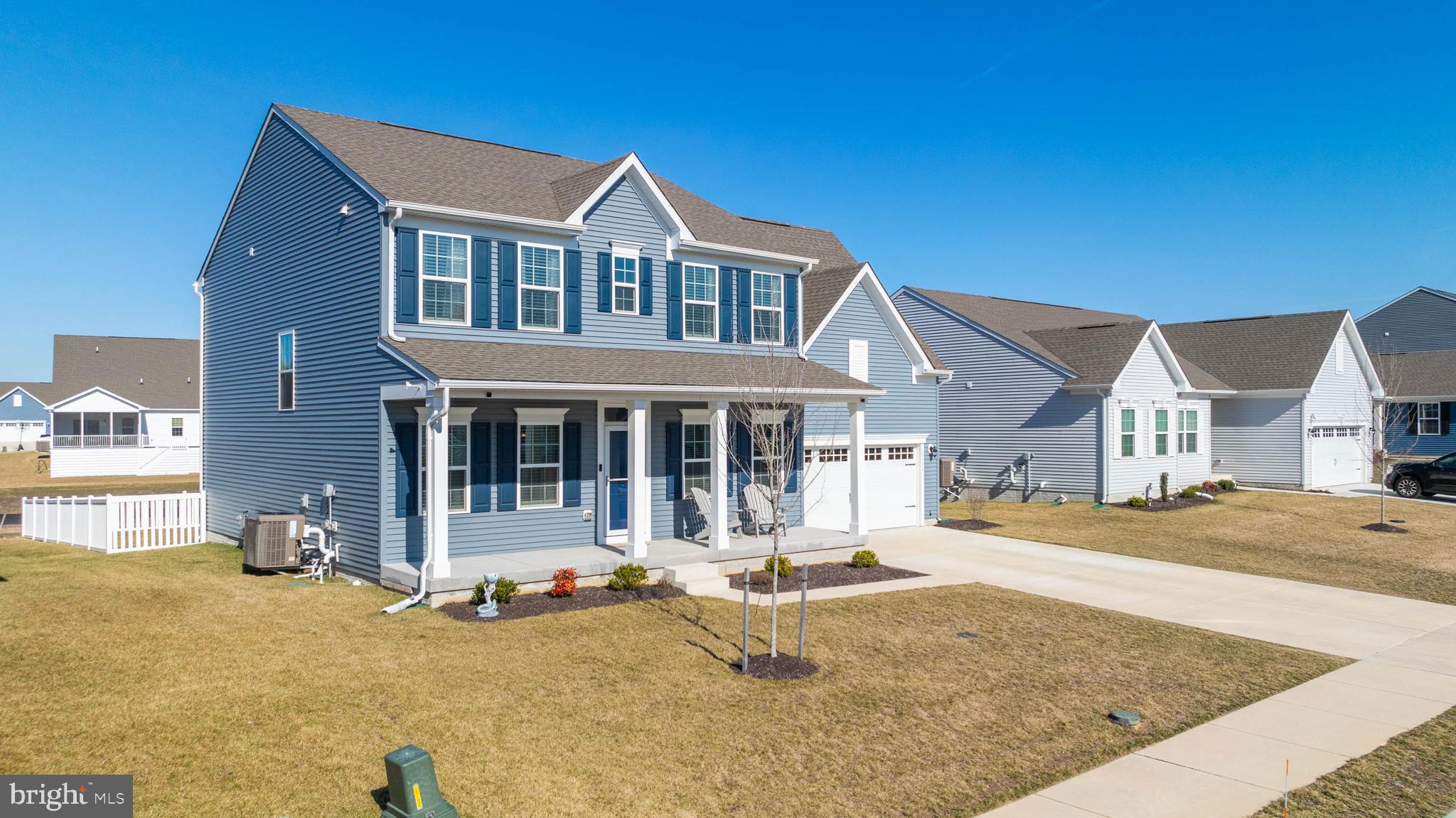 19079 Trimaran Drive Lewes, DE 19958 - Photo 2 of 61 a front view of a house with a yard outdoor seating and covered with tall trees