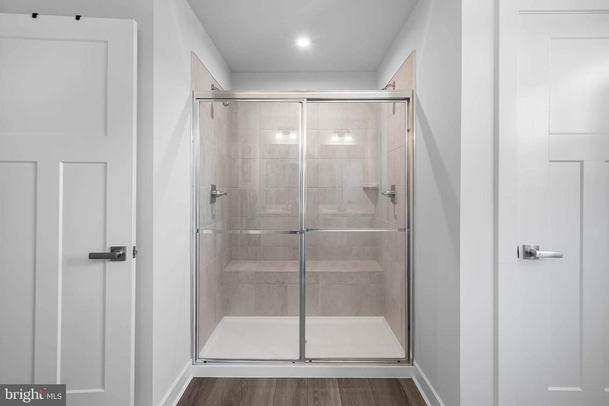 19079 Trimaran Drive Lewes, DE 19958 - Photo 31 of 61 a bathroom with a glass shower door