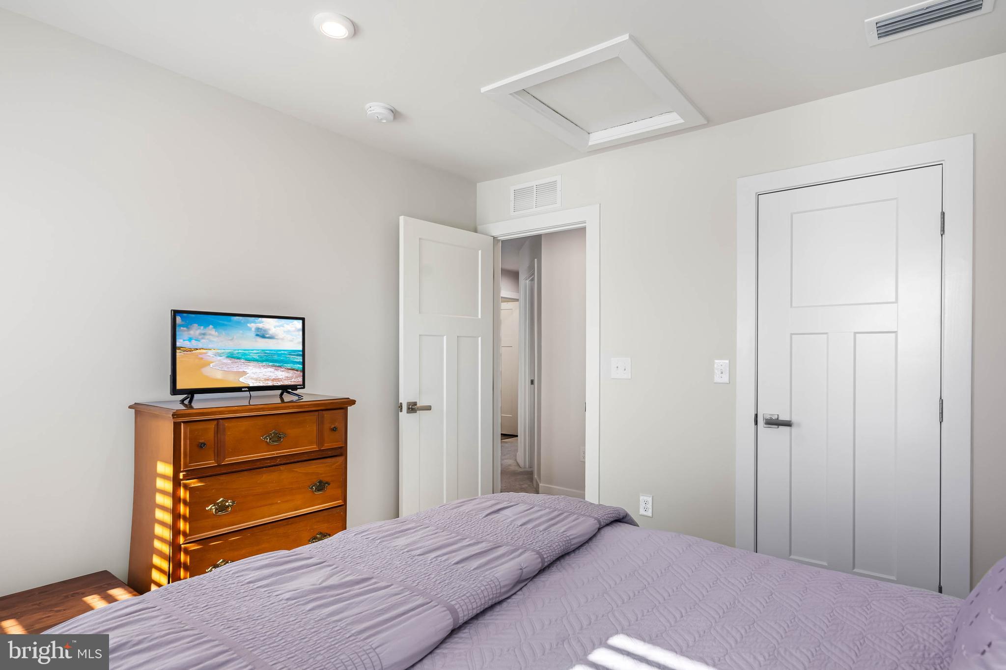 19079 Trimaran Drive Lewes, DE 19958 - Photo 35 of 61 a bedroom with a bed and wooden floor