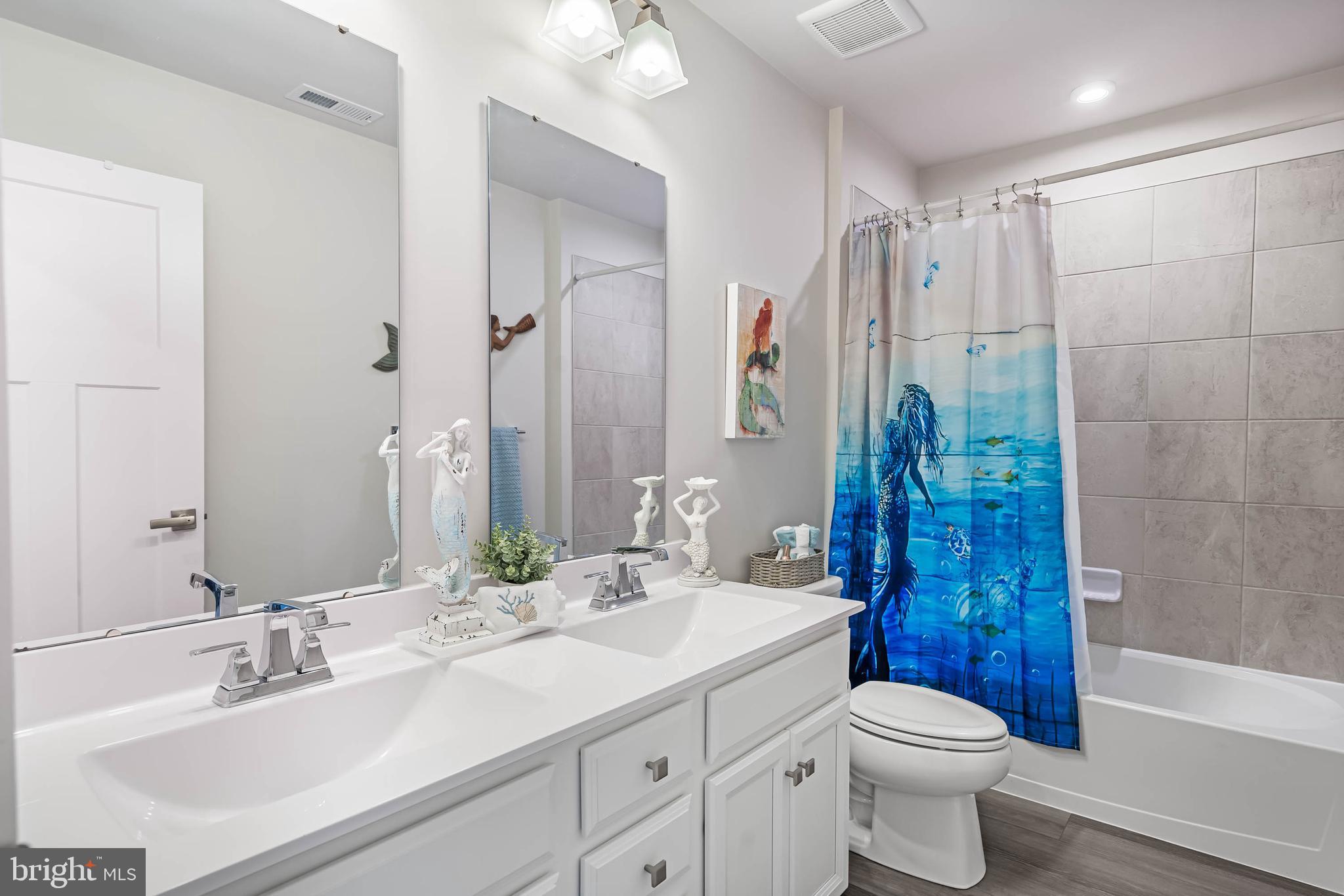 19079 Trimaran Drive Lewes, DE 19958 - Photo 36 of 61 a bathroom with a double vanity sink toilet and shower