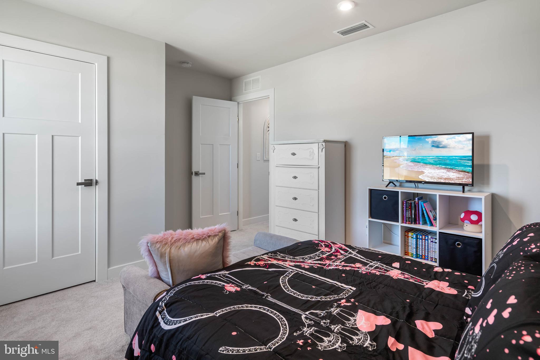 19079 Trimaran Drive Lewes, DE 19958 - Photo 38 of 61 a bedroom with a bed and a bookshelf