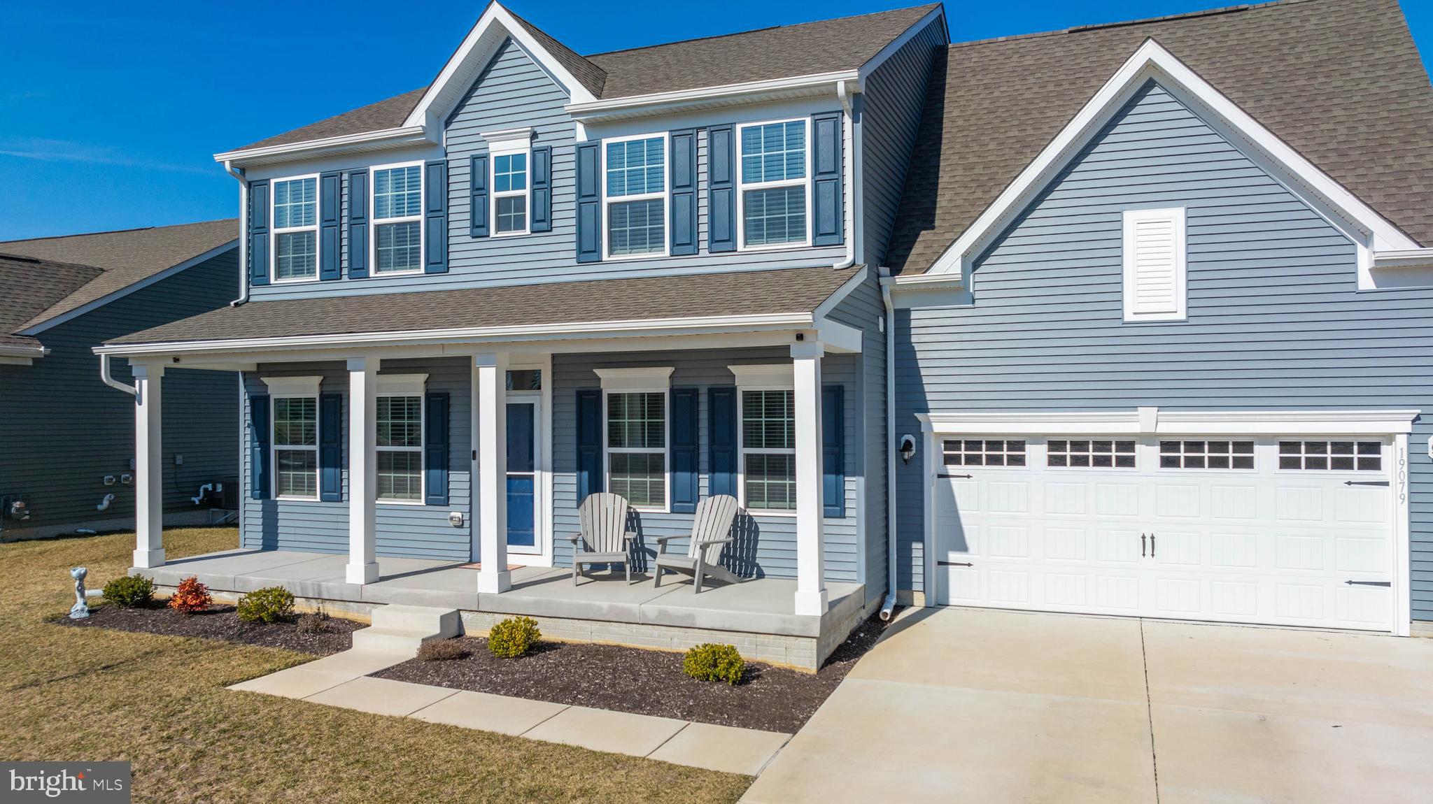 19079 Trimaran Drive Lewes, DE 19958 - Photo 4 of 61 a front view of a house with swimming pool and glass windows