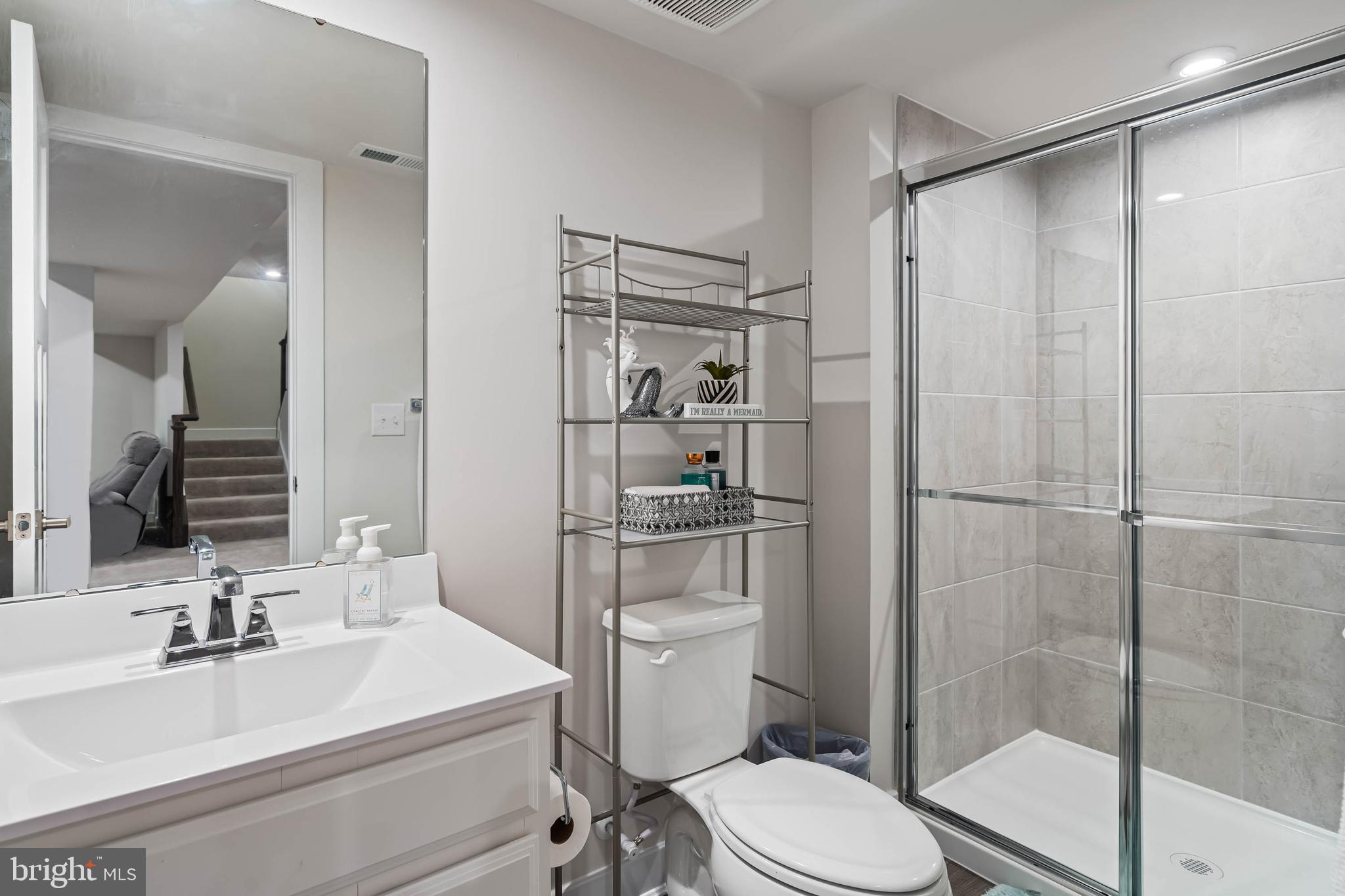 19079 Trimaran Drive Lewes, DE 19958 - Photo 44 of 61 a bathroom with a sink toilet vanity and shower
