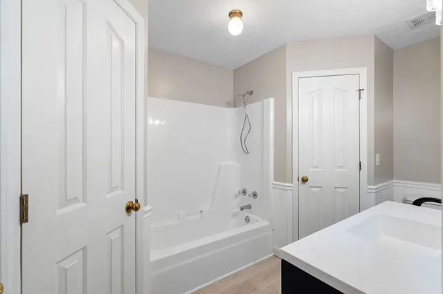 a bathroom with a bathtub and a shower