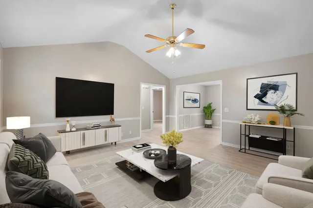 a living room with furniture and a flat screen tv