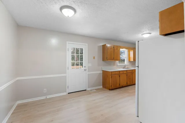an empty room with a fireplace and window
