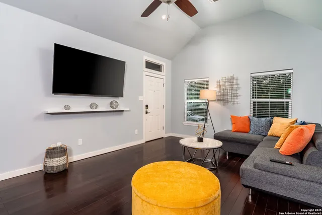 a living room with furniture and a flat screen tv