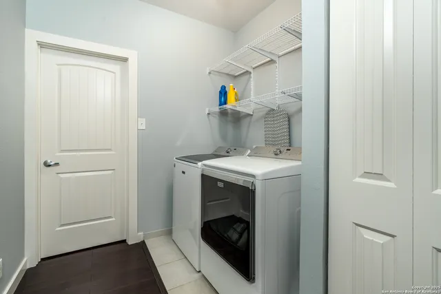 a utility room with sink dryer and washer