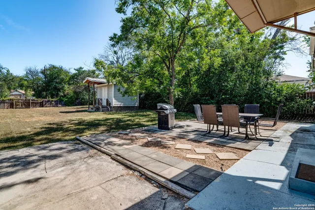 a view of a backyard with sitting area