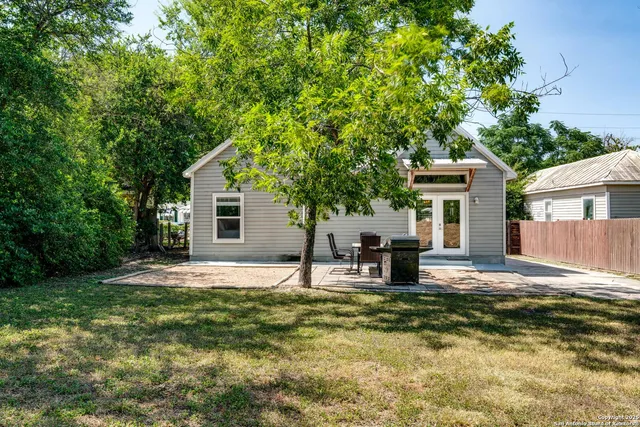 a house view with a sitting space and garden